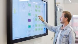 man-presenting-interactive-whiteboard
